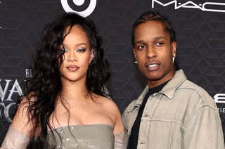 Rihanna and ASAP Rocky on a red carpet: Rihanna in a strapless shiny gown and gloves, Rocky in a casual jacket and pants