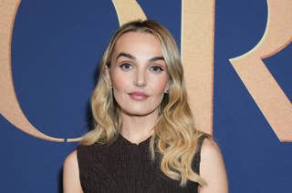 Chloe Fineman on red carpet in sleeveless textured crop top, long hair styled in loose waves