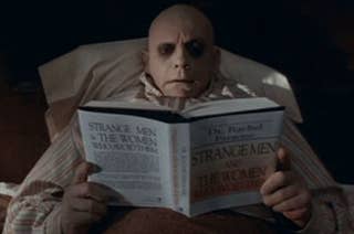 Bald character in stripe pajamas reading a book titled