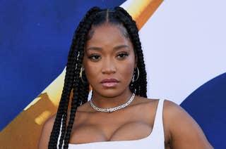 Keke Palmer wearing a stylish sleeveless top with long braided hair, posing at an event