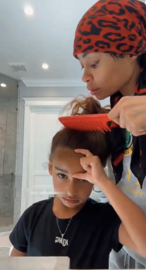 Blac Chyna combs a Dream's hair while wearing a headscarf. Tweet caption: "She's breaking the cycle"